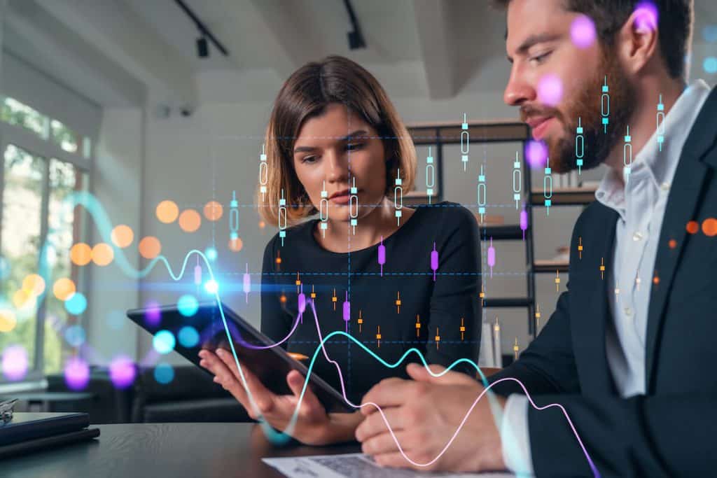 Forex API: co-workers looking at a tablet